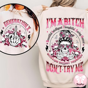 May include: A cream-colored sweatshirt with a graphic design featuring a skull with sunglasses, roses, and the text "I'M A BITCH DON'T TRY ME". The front of the sweatshirt has a circular design with a skeleton hand giving the middle finger, skulls, roses, and the text "GENERATION X".