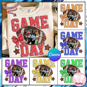 May include: A cream-colored sweatshirt with the words "GAME DAY" in red glitter lettering. A football-shaped graphic with a photo of a football player is in the center. Additional graphics include a red bow and brown stars.
