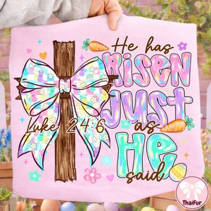 May include: A light pink Easter-themed graphic featuring a wooden cross with a large bow adorned with bunnies and flowers. The text reads "He has Risen JUST as HE said" and "Luke 24:6". Carrots and Easter eggs are also included.