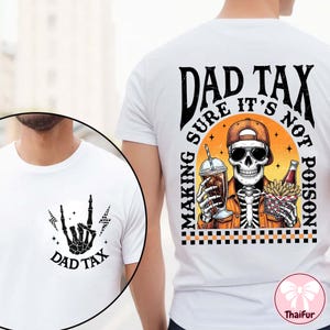 May include: White t-shirt with a graphic of a skeleton wearing sunglasses and a cap, holding a drink and fries. The text "DAD TAX" is displayed on the front and back of the shirt. The back of the shirt also says "MAKING SURE IT'S NOT POISON".