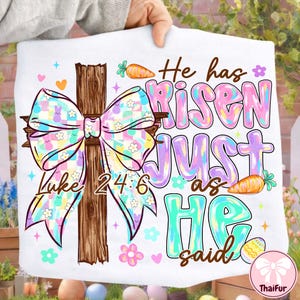 May include: White Easter-themed decorative pillow with a cross, a colorful bow, and the text "He has Risen JUST as HE said" and "Luke 24:6". The design includes carrots, flowers, and Easter eggs.