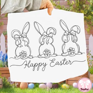 May include: White Easter-themed decorative sign featuring three line-drawn bunny silhouettes with bows and floral accents. The words "Happy Easter" are written in a cursive font below the bunnies. The sign is held up by a person.