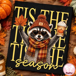 May include: A black rectangular sign featuring a raccoon wearing a brown knit hat with a maple leaf patch, heart-shaped sunglasses, and a plaid scarf. The raccoon holds an orange leaf and a coffee cup with a pumpkin print. Text reads TIS THE SEASON.