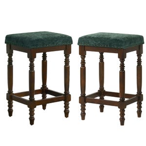 May include: Two dark wood bar stools with green velvet seats. The seats are square and have a button-tufted design. The legs are turned and have a decorative design. The stools have a footrest.
