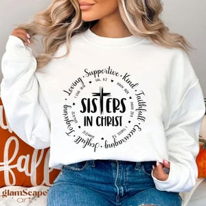 May include: White sweatshirt with a black circle graphic that says "Sisters in Christ" with bible verses around the circle.