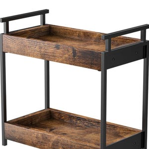 May include: Two-tiered shelf with a rustic, wooden appearance. The shelves are a warm brown with visible wood grain, supported by a black metal frame. The design features a rectangular shape with a handle on each shelf.