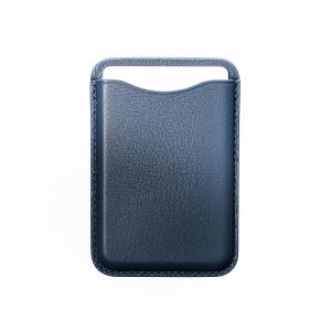 May include: A navy blue leather phone case with a handle at the top. The case has a textured surface and a curved cutout at the top for easy access to the phone. The edges are stitched with a contrasting thread.