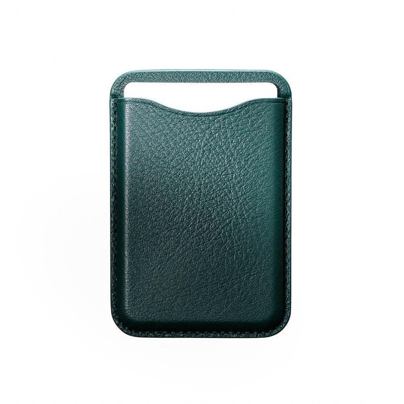 May include: A teal green leather phone sleeve with a textured surface. The sleeve has a rectangular shape with a curved top and a handle at the top. The edges are stitched with a contrasting thread.