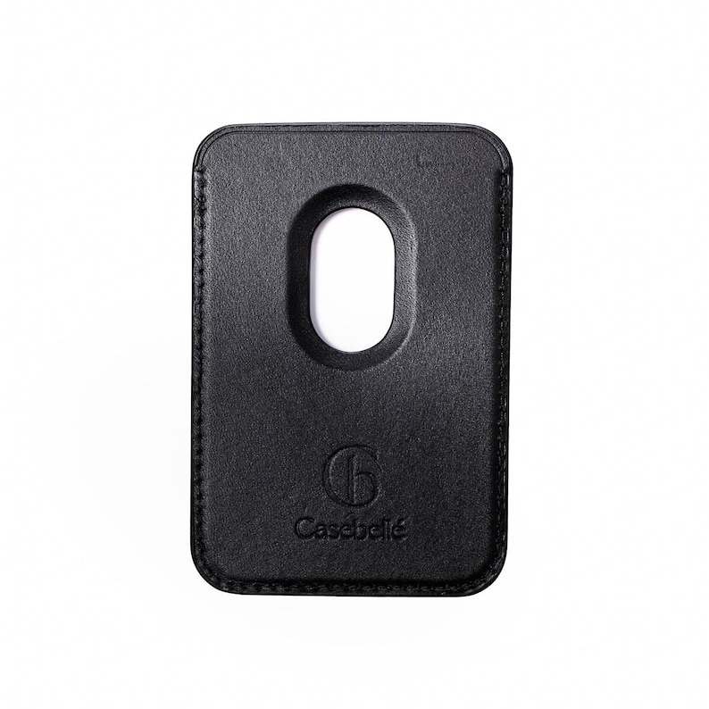 May include: A black leather phone case with a rounded rectangular shape and a large oval cutout. The case has a stitched border and the Casebelle logo is embossed at the bottom.