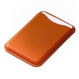 May include: A rectangular, orange leather card holder with a white card partially visible in the top slot. The card holder has a stitched border and a smooth, textured surface. The design is simple and functional.