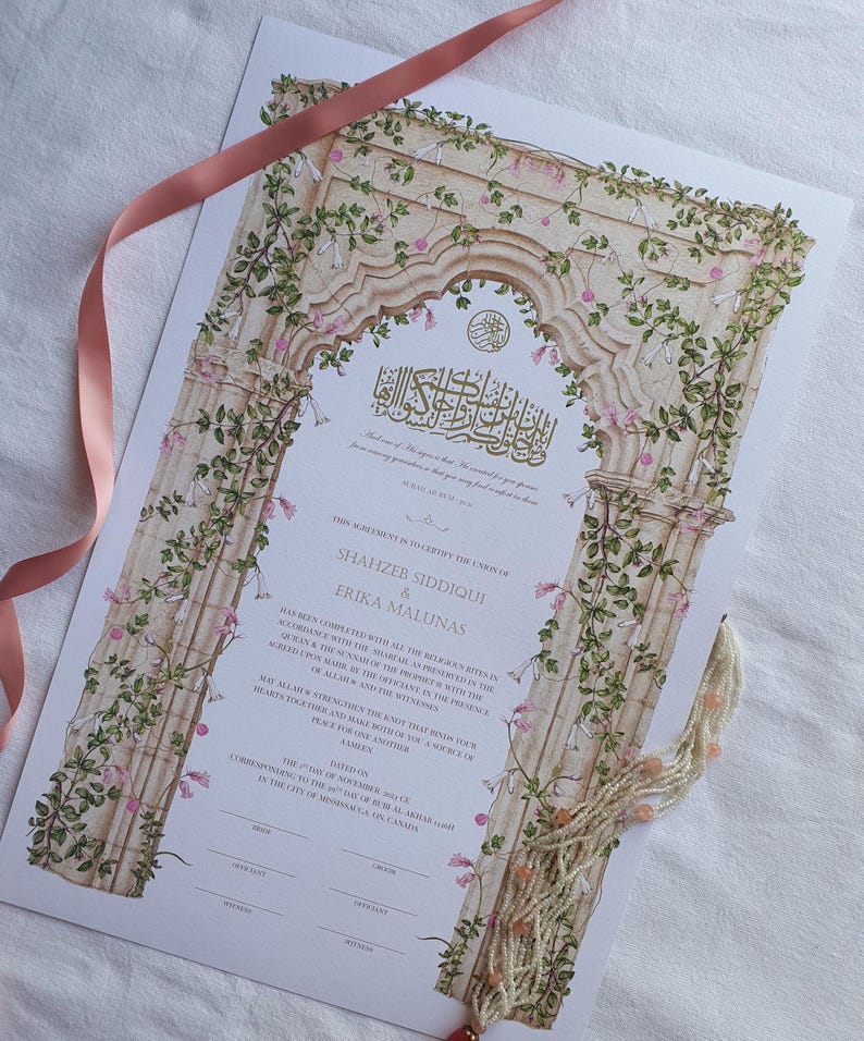 May include: A wedding certificate featuring an illustration of a stone archway covered in green vines and pink flowers. The document includes printed text with the names Shahzeb Siddiqui and Erika Malunas, along with a pink ribbon and beaded tassel.