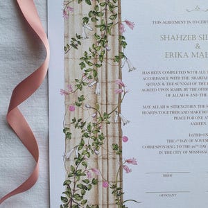 May include: A wedding certificate featuring a vertical illustration of a stone column entwined with green vines and pink bell-shaped flowers. The document includes printed text and blank lines for signatures, accompanied by a soft pink ribbon.