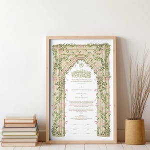 May include: A rectangular framed print featuring an ornate stone archway illustration adorned with green vines and small pink flowers. The center contains Arabic calligraphy and English text with the names JODI NAAM and SALAR SHAHI printed in black.
