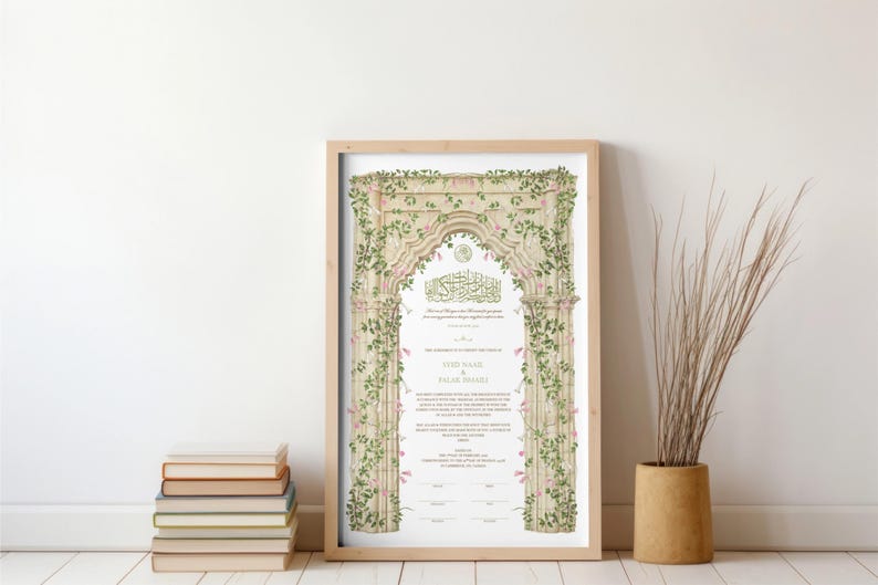 May include: A rectangular framed print featuring an ornate stone archway illustration adorned with green vines and small pink flowers. The center contains Arabic calligraphy and English text with the names JODI NAAM and SALAR SHAHI printed in black.