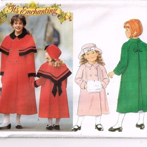 May include: A sewing pattern for three children's coats. The pattern includes a red coat with a cape, a red coat with a bow, and a green coat with a bow. The pattern is called "It's Enchanting".
