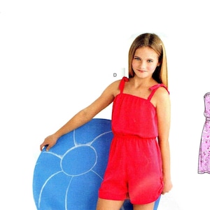 May include: A young girl wearing a red sleeveless jumpsuit with a tie at the shoulders. She is holding a blue inflatable beach ball.