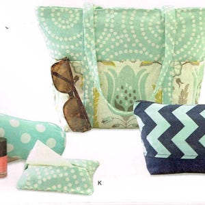 May include: A set of four fabric bags in various patterns. The bags are made of a light green fabric with white polka dots, a light green fabric with a floral pattern, a light blue fabric with a chevron pattern, and a dark blue fabric with a chevron pattern. The bags are all lined with a dark blue fabric. The bags are all handmade and are perfect for carrying everyday essentials.