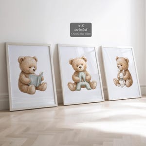 May include: Three framed prints featuring watercolor illustrations of teddy bears. One bear reads a book, another holds the letter "A", and the third holds a small white bunny. The prints are in white frames and include the text "A-Z included +4 extra side prints".