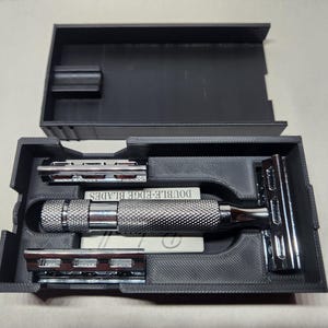 May include: A set of three ceramic vases in varying heights and shapes. The vases feature a speckled, matte finish in shades of cream, beige, and brown. The tallest vase is approximately 10 inches high.