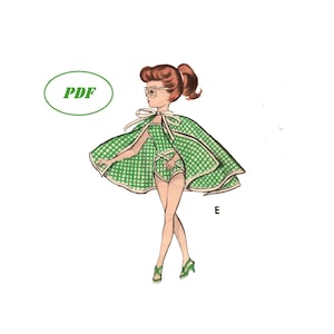 May include: A green and white gingham cape with a matching swimsuit. The cape has a bow at the neck and the swimsuit has a scoop neck and a high leg cut. The model is wearing the outfit and has red hair and glasses. The text "PDF" is in a green circle.