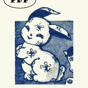 May include: A white rabbit with blue floral pattern on a blue background. The rabbit is sitting up with its ears up and its eyes closed. The rabbit is smiling.