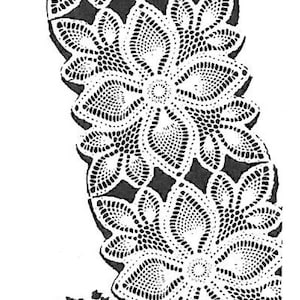 Puede incluir: Una imagen en blanco y negro de un encaje de ganchillo con un diseño floral. El encaje tiene forma de flor con múltiples capas de pétalos. El encaje se coloca encima de un jarrón con un diseño floral.