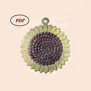 May include: A crocheted sunflower pot holder with a brown center and yellow petals. The pot holder has a green loop for hanging.