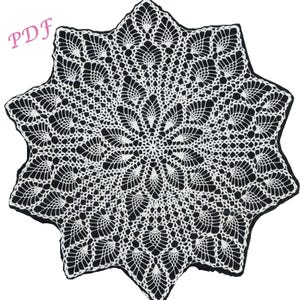 May include: A white crochet doily with a starburst design. The doily is made with delicate stitches and has a scalloped edge.