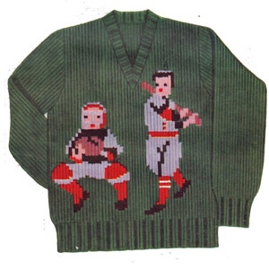 May include: Green knitted sweater with a baseball theme. The sweater features two baseball players, one in a catcher's position and the other holding a bat.