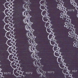 May include: A close-up of ten different white lace trims with numbers 9069, 9078, 9071, 9073, 9072, 9070.