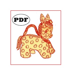 May include: A printable PDF pattern for a spotted, red-outlined, stuffed animal toy shaped like a pony. The pattern includes a bow on the pony's head and a handle on the back.