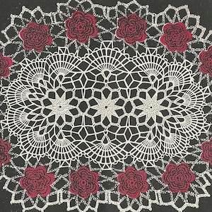 May include: White crochet doily with a delicate floral pattern and a border of red roses.