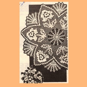 May include: A black and white crocheted doily with a circular design. The doily has a center with a smaller circle and eight points radiating out from the center.