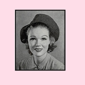 May include: A black and white photo of a woman wearing a wide-brimmed hat with a crocheted texture.