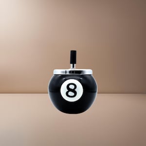 May include: Black and white 8-ball ashtray with a silver top.