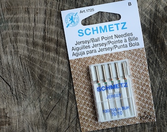 May include: A package of 5 Schmetz Jersey/Ball Point needles in a clear plastic case. The package is labeled with the brand name, product description, and size: 130/705 H SUK 70/10.