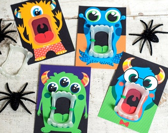 May include: Four colorful monster cards with open mouths and fangs. Each card has a different monster with a unique expression and features. The cards are printed on white cardstock and are perfect for a Halloween party or craft project.