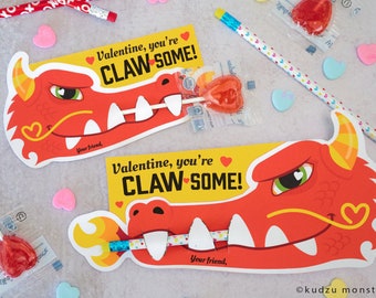 May include: Two red dragon Valentine's Day cards with a heart-shaped lollipop sticking out of the dragon's mouth. The cards say "Valentine, you're CLAW-SOME!"