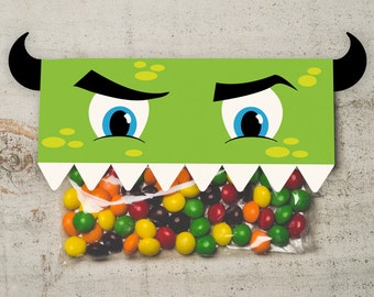 May include: Green monster treat bag with googly eyes and a toothy grin. The bag is filled with colorful candy. www.etsy.com/shop/kudzumonster