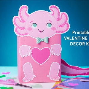 May include: Printable Valentine's Day box decor kit featuring a pink axolotl with a bow tie and a heart. The kit includes a box, axolotl, heart, and other decorations.