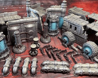 May include: A collection of miniature gray industrial terrain pieces featuring metallic walls, cylindrical towers with glowing blue light accents, and various pipe segments. The set includes modular building sections, detailed machinery components, and curved piping elements designed for tabletop gaming environments.