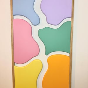 Relief painting with solid wooden frame in pastel colors