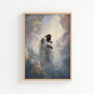 May include: Framed art print showing two figures in white robes embracing within a cloudscape. A warm light shines from above. The artwork is set within a light-coloured wooden frame, suitable for home decor.