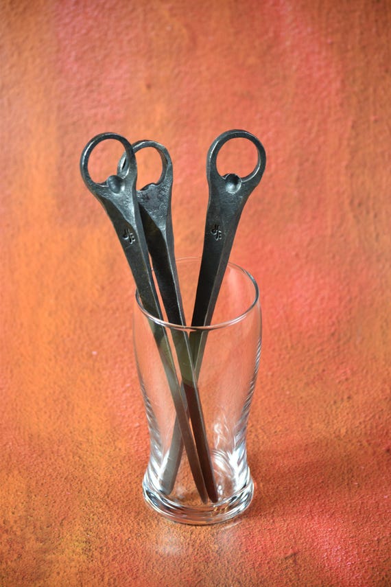 Actually forged by a blacksmith over an open fire — the hammer marks and raw iron texture make this a bottle opener that tells a story every time someone picks it up.