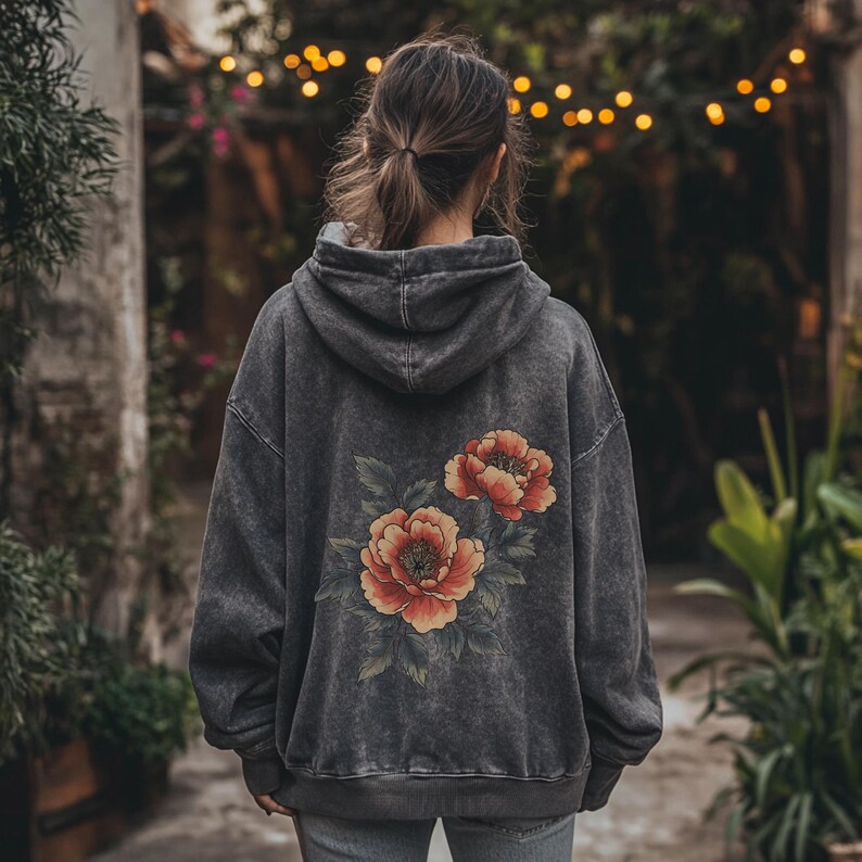 May include: A gray hooded sweatshirt with a floral print on the back. The flowers are red, orange, and yellow.