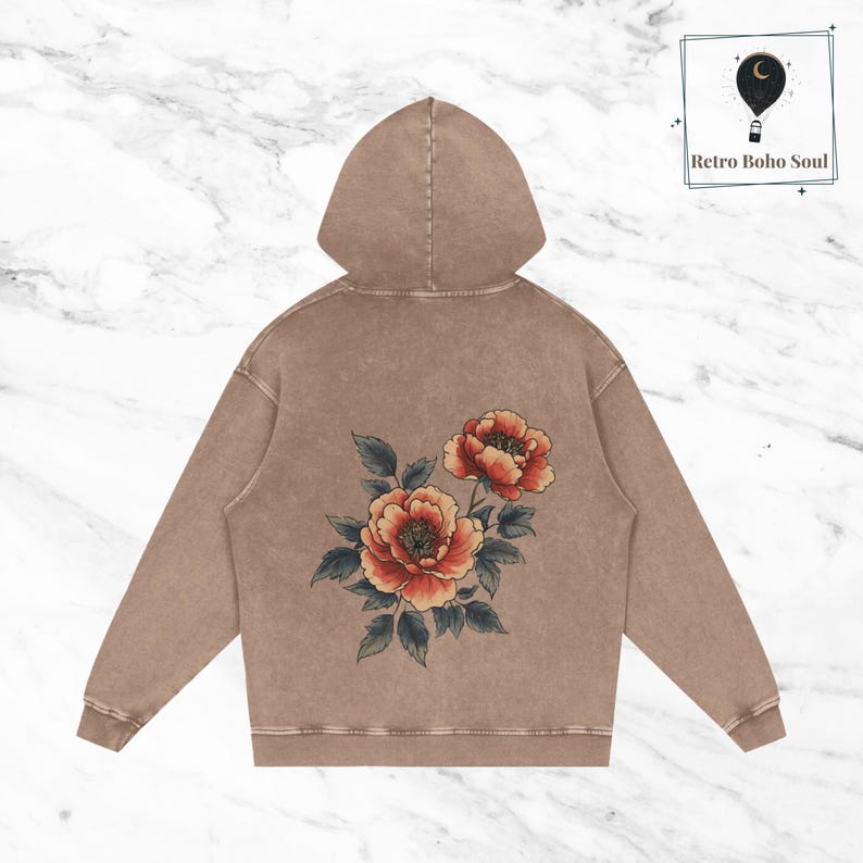 May include: A brown hoodie with a floral design on the back. The flowers are red, orange, and yellow with green leaves.