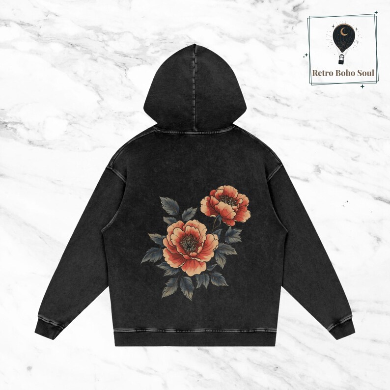 May include: Black hooded sweatshirt with a vintage wash and a floral design on the back. The flowers are red, orange, and green.