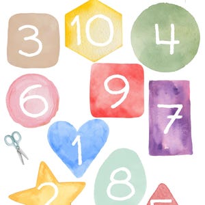 May include: A colorful educational activity for kids featuring ten watercolor painted shapes with numbers 1 through 10 written in white. The text on the page reads "Schneide die Zahlen aus und sortiere sie nach der Reihenfolge.  Вырежь числа и разложи их по порядку. (Viresch tschisla i razlazhi ich po porjadku.)"