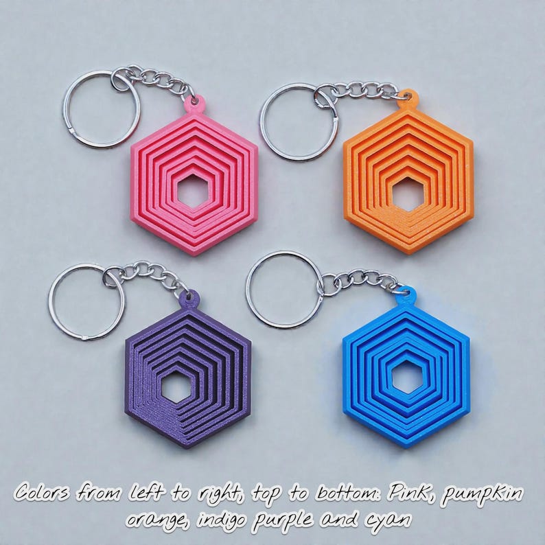 Handmade and customizable hex fidget keychains shown in assorted colors, featuring colorful designs, perfect for kids birthday parties, classroom prizes, sensory play, and party favor gifts.