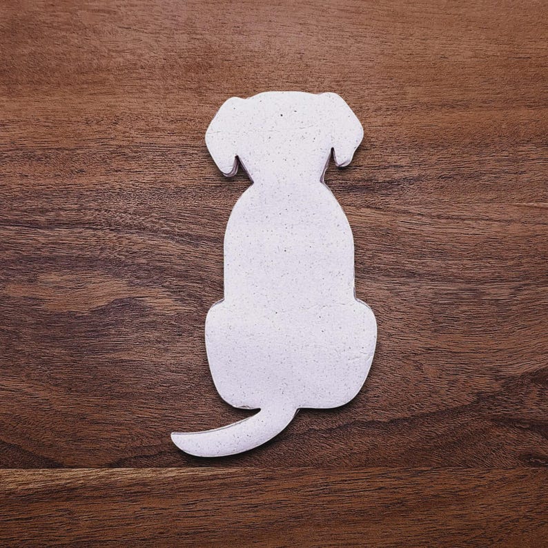 Dog-shaped cookie dough cutout on baking surface, perfect for pet-themed treats, parties, or homemade dog cookies – eco-friendly and handmade.